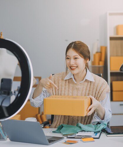young-woman-freelancer-working-sme-business-online-shopping-packing-clothes-with-cardboard-box-home-business-online-shipping-delivery-concept_265022-90616.jpg